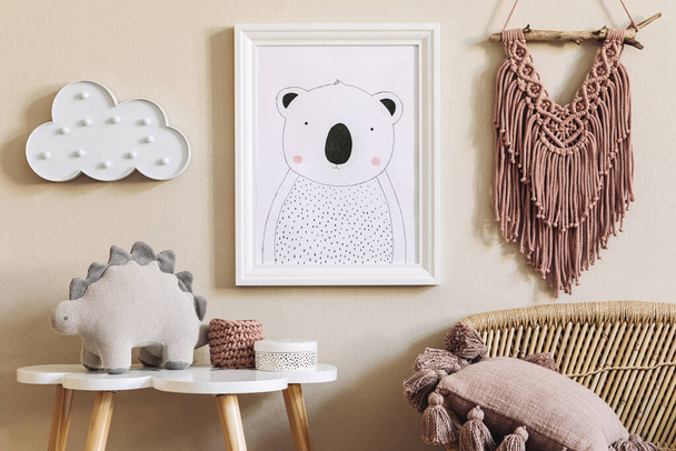 Stylish scandinavian nursery interior with mock up photo frame, toy, design furniture, pillows and accessories. Beautiful decoration on the beige background wall. Home decor for children room. - Photo, image