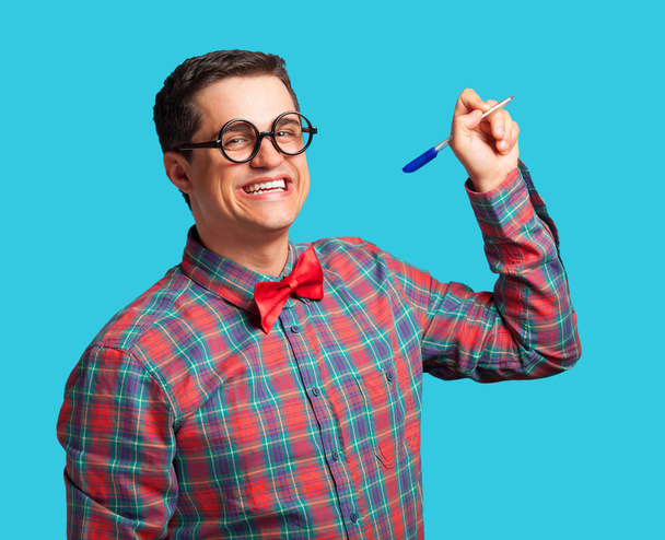 Nerd with pen and glasses on blue background. - Photo, Image
