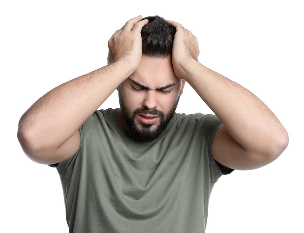 Young man suffering from headache on white background - Zdjęcie, obraz