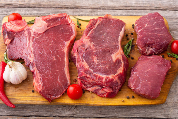 Assortment of raw beef steak . T-bone , ribeye and fillet mignon . Food background - Photo, image