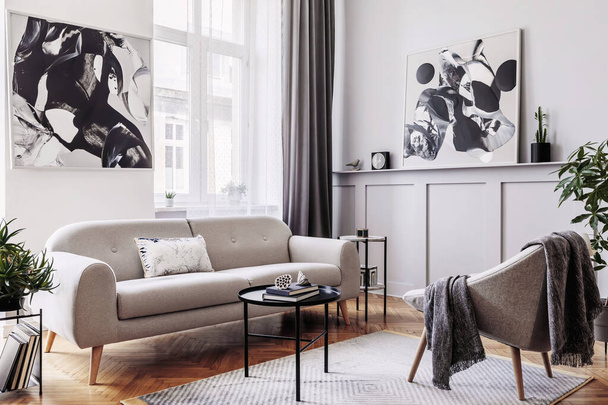 Stylish scandinavian home interior of living room with design gray sofa, armchair, marble stool, black coffee table, modern paintings, decoration, plant and elegant personal accessories in home decor. - Photo, image