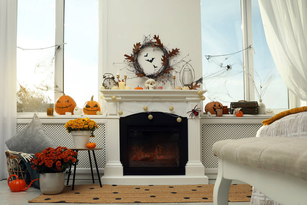 Modern room with fireplace decorated for Halloween. Festive interior - Zdjęcie, obraz