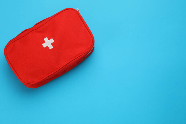 First aid kit bag on light blue background, top view. Space for text - Foto, afbeelding