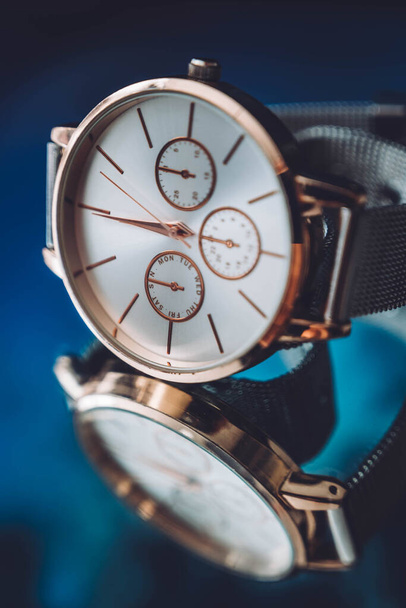 Close up of golden elegant luxury watch wristwatch on black mirror background - Photo, Image