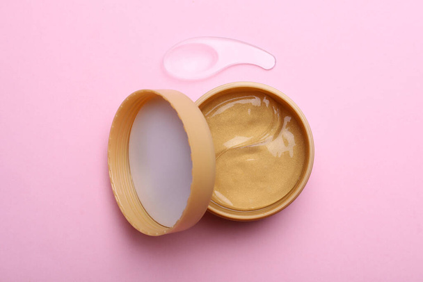 Package of under eye patches on pink background, flat lay. Cosmetic product - Фото, зображення
