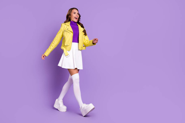 Full size profile side photo of young excited girl wear modern clothes go meeting isolated over purple color background - 写真・画像