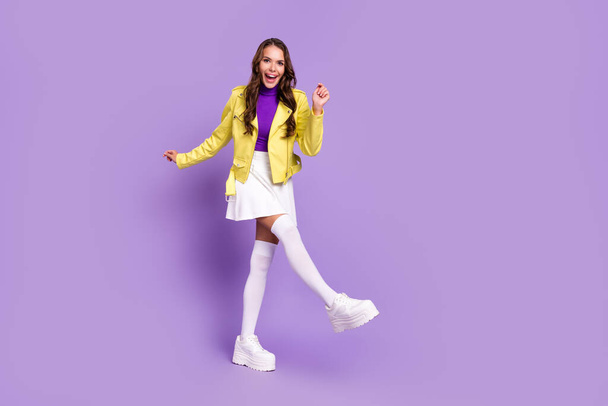 Full length photo of young cheerful girl have fun dancer party modern outfit platform isolated over purple color background - Fotografie, Obrázek