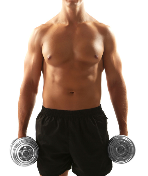 Handsome young muscular sportsman execute exercise with dumbbells isolated on white - Zdjęcie, obraz