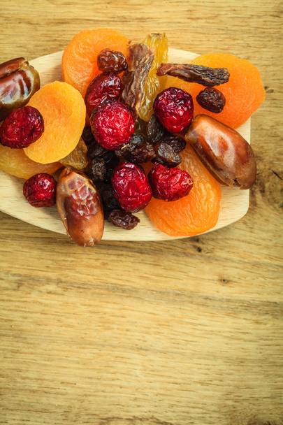 Varieties of dried fruits on wooden spoon. - Foto, imagen