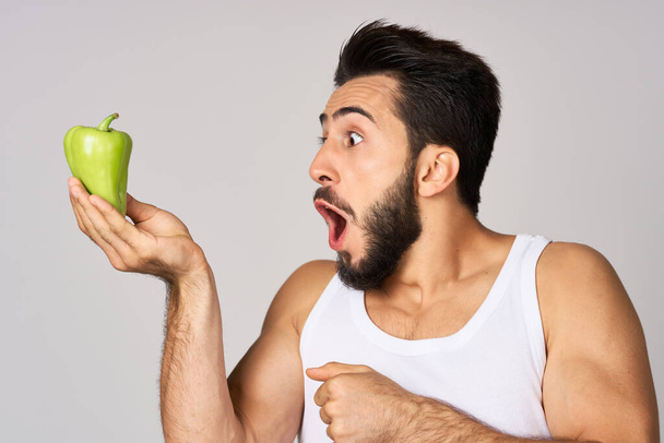 bearded man green pepper snack healthy food emotions - Φωτογραφία, εικόνα