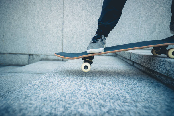 Skateboarder riding  skateboard goring down the stairs outdoors in city - Zdjęcie, obraz