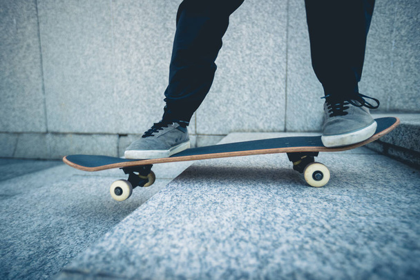 Skateboarder riding  skateboard goring down the stairs outdoors in city - Fotoğraf, Görsel
