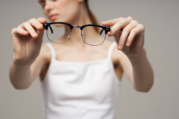 vrouw bril in de handen van astigmatisme studio behandeling - Foto, afbeelding