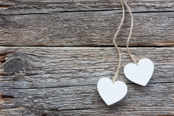 Two white hearts on old wooden surface - Foto, imagen