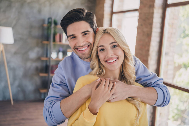 Photo of young cheerful couple happy positive smile spouses romance embrace love girlfriend boyfriend indoors - Foto, afbeelding
