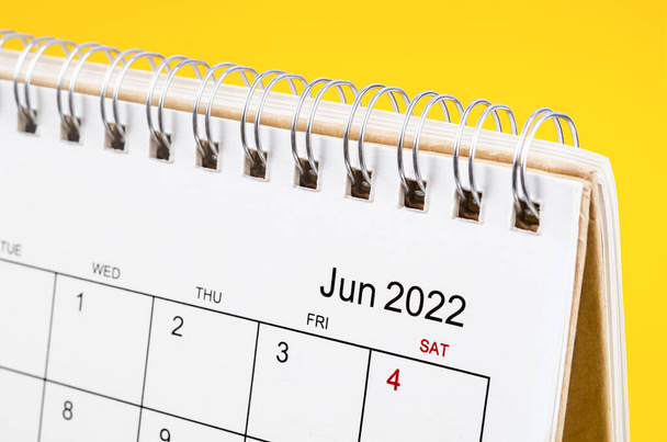 Close-up June 2022 desk calendar on yellow background. - Φωτογραφία, εικόνα