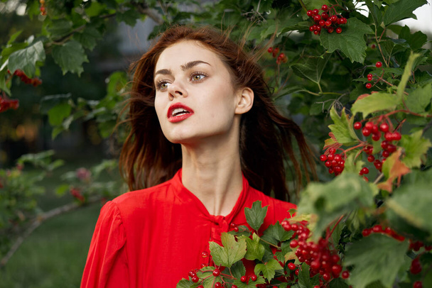 pretty woman in red shirt nature green leaves summer - Photo, Image