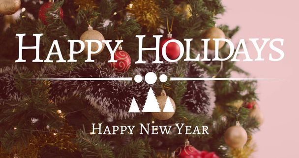 Image of happy holidays and happy new year christmas text over christmas tree in background. christmas, tradition and celebration concept digitally generated image. - Foto, afbeelding