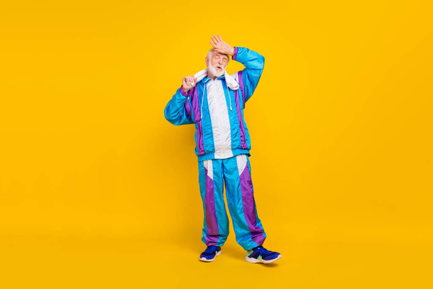 Full size photo of senior man activity after intense exercise exhausted old-fashioned costume isolated over yellow color background. - Zdjęcie, obraz