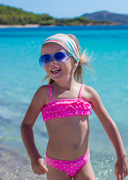 Adorable little girl have fun at tropical beach during vacation - Photo, Image
