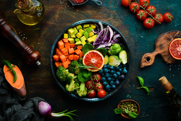Vegan Buddha Bowl: Sweet Potatoes, Blueberries, Avocados, Cabbage and Orange. Dietary food. Top view. Free space for your text. - Fotoğraf, Görsel