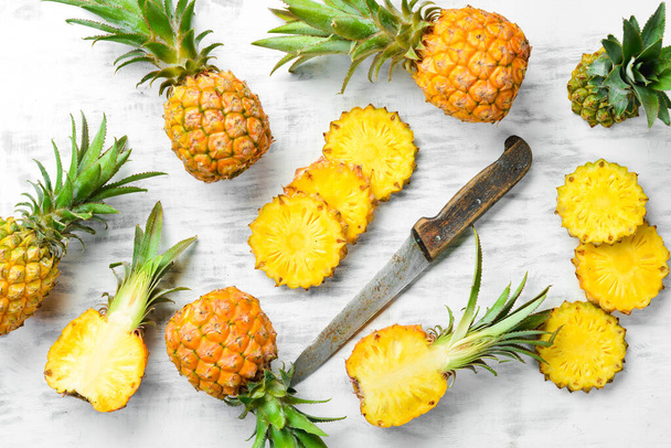 Mini pineapple on wooden table. Top view. Free space for text. - Φωτογραφία, εικόνα