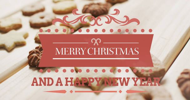 Image of merry christmas text over cookies. christmas, winter, tradition and celebration concept digitally generated image. - 写真・画像