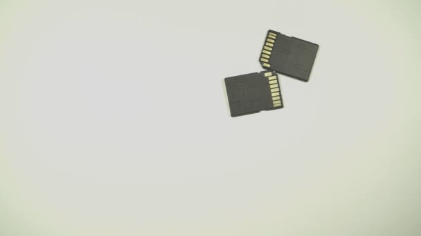 Clips video 4k and full HD of memory SD card isolated on clean background this sd card for various computer, digital camera and smart mobile phone devices. - Filmati, video