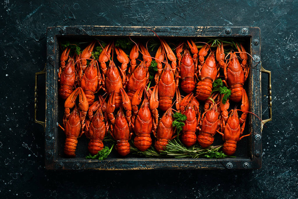 Big set of red crayfish in a wooden box. Seafood. Top view. Flat lay. - Foto, Imagem