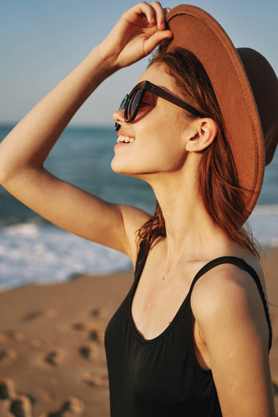 pretty woman in hat and sunglasses on the beach walk sun - 写真・画像