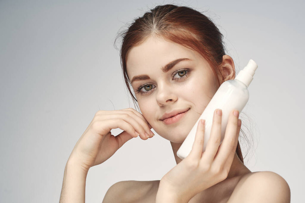 woman with bare shoulders cosmetics procedures skin care cream - Foto, Imagen