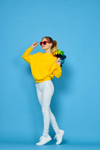 woman with multicolored umbrella in yellow sweater posing rainbow colors - Foto, imagen