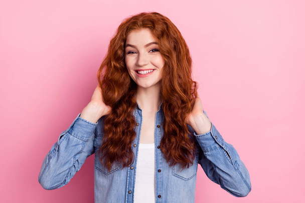 Photo of young attractive girl happy positive smile hands touch foxy hair new hairdo isolated over pink color background - Fotó, kép
