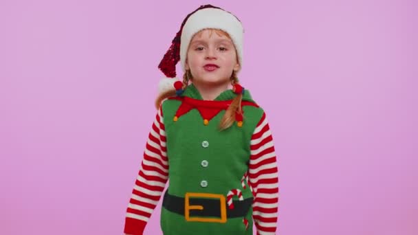 Displeased child girl Christmas Elf gesturing hands with displeasure, blaming scolding for failure - Footage, Video