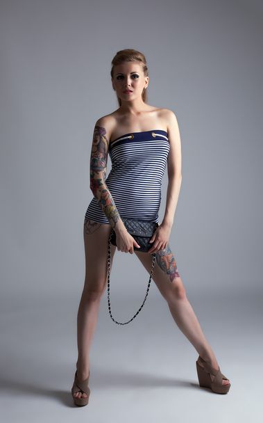 Hot tattooed woman posing looking at camera - 写真・画像