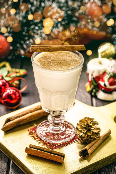 glass of hot eggnog, Christmas drink, based on eggs, cinnamon, almonds and rum liqueur. called eggnog, milk and pisco, coquito or Creme de Vie - Photo, Image