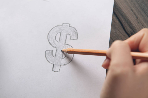 woman draws dollar sign on paper - Photo, Image