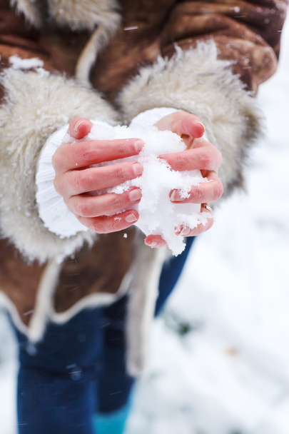 Hands of woman with snow heart - Foto, imagen