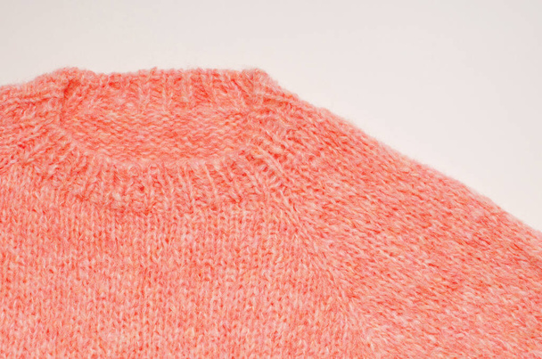 a fragment of a hand knitted woolen sweater on a white background. close up - Фото, зображення