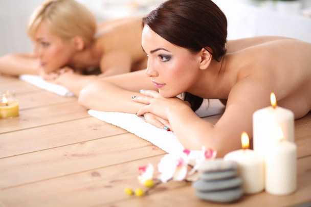 Two young beautiful women relaxing and enjoying at the spa center - Fotoğraf, Görsel