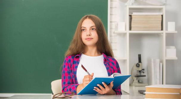 smart teen girl ready to study. kid do homework with book. teenager student. modern education - Photo, Image