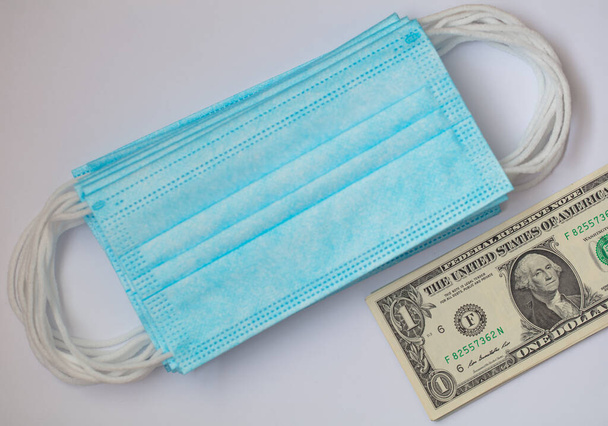 surgical masks and 1 dollar banknote - Фото, зображення