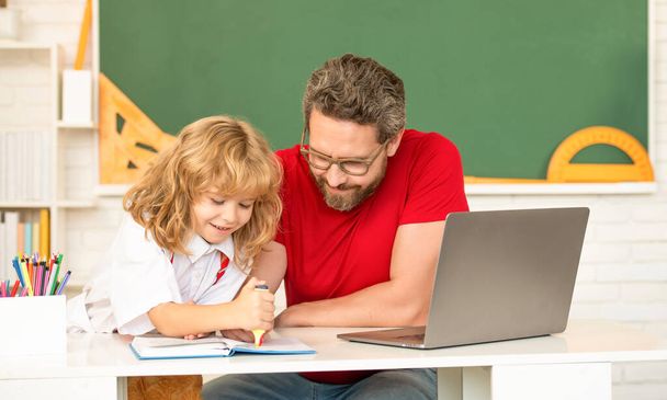 gyermekkor és szülőség. Mosolygó fiú magántanárral tanul. webinar videó lecke. - Fotó, kép