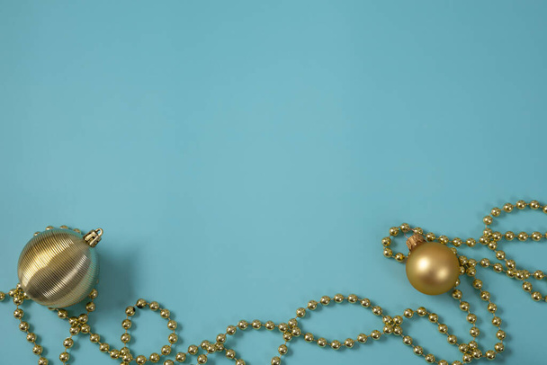 Золоті різдвяні прикраси на синьому фоні
 - Фото, зображення