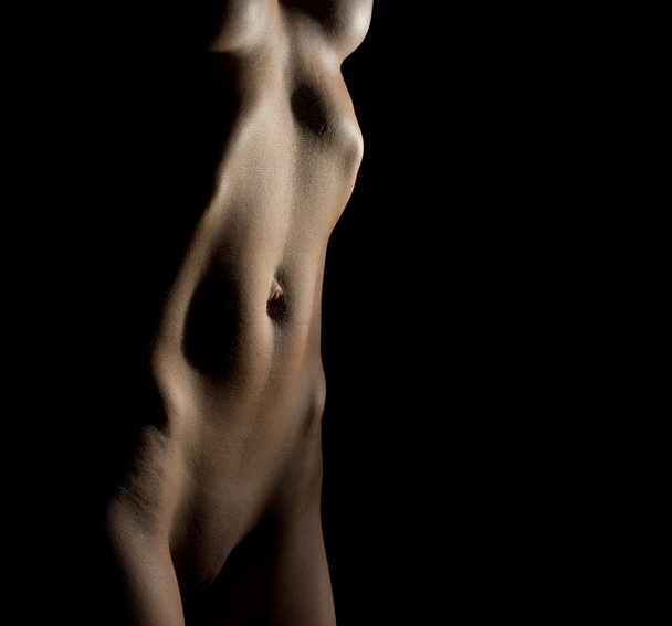 Sexy naked unrecognizable woman body on black background.     - Foto, afbeelding