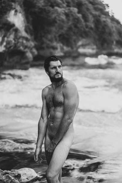 Naked man on the ocean. The unity of man with nature. - Valokuva, kuva