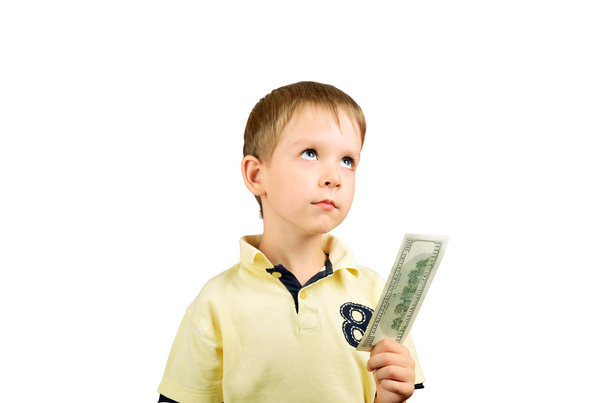 little boy looking up, takes a bill 100 US dollars and think wha - Photo, Image