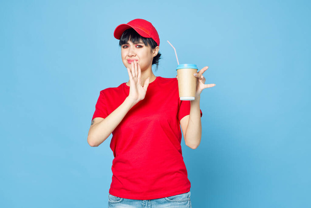 woman in red uniform cup of coffee blue background fun - Fotó, kép