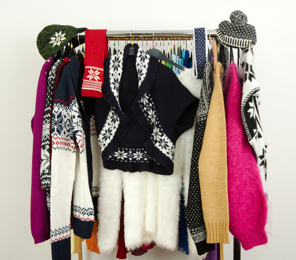 Cute sweaters with snowflakes displayed on a rack. - Zdjęcie, obraz