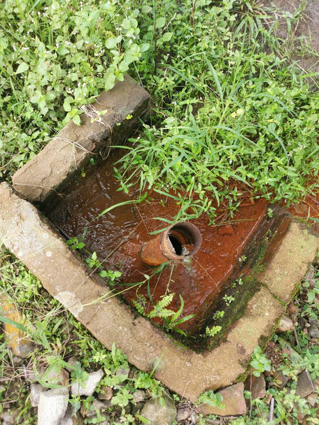corroded water pipe leaking in the farm meadow. - Photo, Image